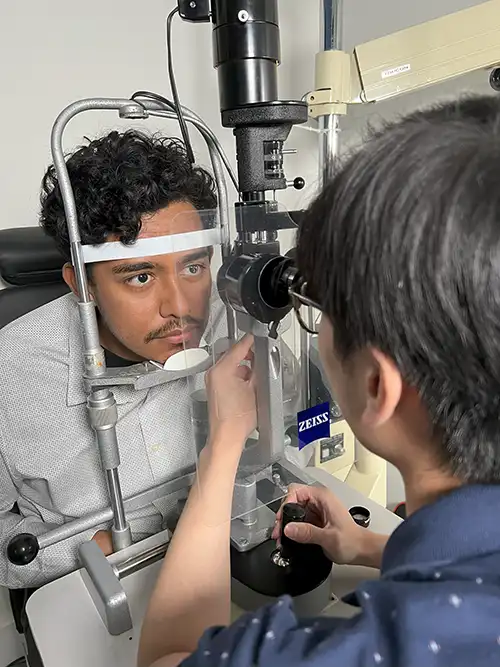 Dr. Cheng examining a patient at the slit lamp